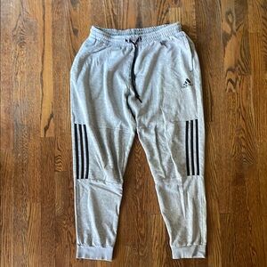 Adidas Light Gray Sweatpants with Black Accents.